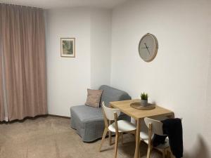 a room with a table and a chair and a clock at UNDERGROUND in Bielsko-Biala