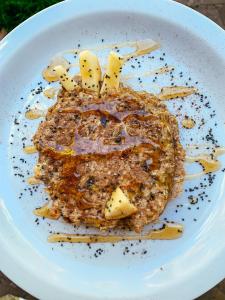 a white plate with a piece of food on it at Chez Max Pousada in Morro de São Paulo