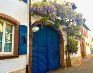 a blue door on the side of a building at La Maison de Caroline in Westhoffen