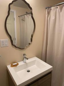 a bathroom with a white sink and a mirror at Starlight Lodge at Rockport Harbor in Rockport