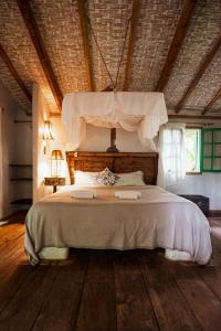 Säng eller sängar i ett rum på Butterfly House Bahia