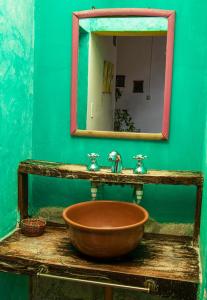 a bathroom with a wooden sink and a mirror at Viracocha Art Hostel Cachi in Cachí