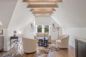 a living room with a couch and chairs and a table at The George - Luxury Boutique Inn in Napa