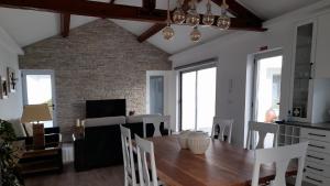 a kitchen and dining room with a table and chairs at Serenity Azores - Casa da Aldeia in Nordestinho