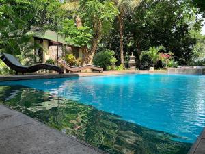 a swimming pool with a slide in the middle at The Village Bunaken in Bunaken