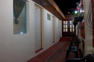 a hallway with chairs and a door with a window at Casa Central de Santa Ana in Santa Ana