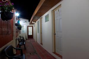 a hallway with chairs and a door in a building at Casa Central de Santa Ana in Santa Ana