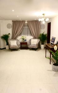 een grote woonkamer met een bed en 2 stoelen bij Casa de hospedaje Vivaio in Paipa