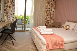a bedroom with a bed with a desk and a chair at The Archontariki in Ormos Panagias
