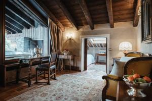 a living room with a table and chairs and a kitchen at Relais Mont Blanc Hotel & Spa in La Salle +41 photos