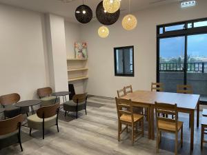 a dining room with a table and chairs at One Night Hostel in Yilan City