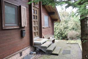 a house with a bench next to a window at Landhaus mit Saunakeller in Bad Wünnenberg