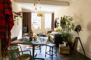 ein Wohnzimmer mit einem Tisch und einem Sofa in der Unterkunft Grassmarket Old Town Boutique Apartment in Edinburgh