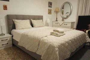 a bedroom with a bed with towels on it at CENTRAL TOWN HOUSE 60m2**** in Piraeus