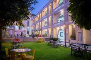 ein Innenhof mit Tischen und Stühlen vor einem Gebäude in der Unterkunft Hotel Pushkar City Inn in Pushkar