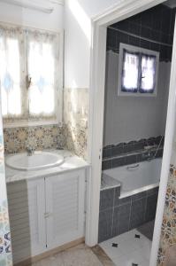 a bathroom with a sink and a bath tub at Dar El Fatimid sur le port de Mahdia free WIFI in Mahdia