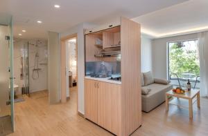 a kitchen and living room with a couch in a room at Triton Boutique Hotel in Kos Town