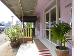 a building with potted plants sitting outside of it at Silver Reef in Udon Thani
