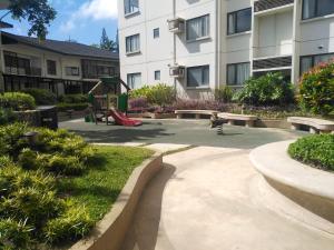 a park with a playground in front of a building at 1Tagaytay in Tagaytay