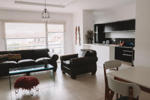 a living room with a couch and a table at Administración MAIPU 2E DEPTO PREMIUM in Tandil