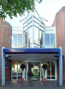 a building with a blue entrance in front of it at Hotel Alexander in Oldenburg