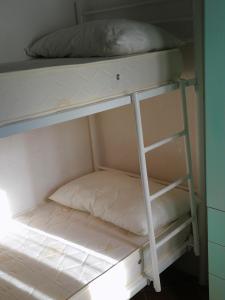 a bunk bed with a pillow on the bottom bunk at ALLOGGIO S.ANNA in Isola del Giglio
