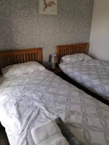 two beds sitting next to each other in a bedroom at 1 Fulmar Road**Next to West Beach and Golf Course in Lossiemouth