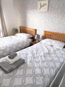 two beds sitting next to each other in a bedroom at 1 Fulmar Road**Next to West Beach and Golf Course in Lossiemouth