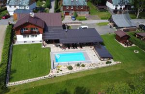 an aerial view of a house with a swimming pool at Chalet Schäfer s vyhřívaným bazénem se slanou vodou in Harrachov