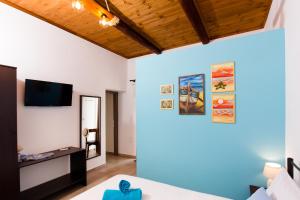 a living room with a couch and a tv at M & E Kissamos sea view house in Kissamos