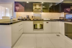 a kitchen with white cabinets and stainless steel appliances at Luxury apartment in Downtown near Dubai Mall in Dubai