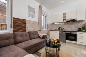a living room with a couch and a table at Apartman Altamar Rijeka in Rijeka