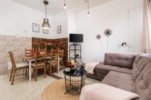 a living room with a couch and a table at Apartman Altamar Rijeka in Rijeka