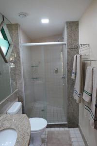a bathroom with a shower and a toilet and a sink at FLAT MARULHOS in Ipojuca
