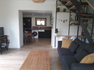 a living room with a couch and a table at La petite brise in Plouër-sur-Rance +23 photos
