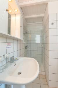 a white bathroom with a sink and a shower at The Kantada Villas Petros, Eleni, Stelios & Dioni in Gaios