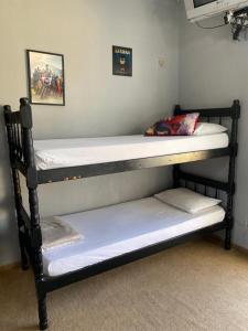 a couple of bunk beds in a room at Pousada Santa Lolla in São Carlos