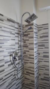 a shower with a shower head in a bathroom at Hotel Mont Blanc in Bellaria-Igea Marina