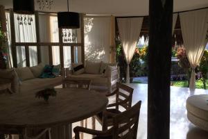 a living room with a couch and a table and chairs at Fortamu - Tembo House in Watamu