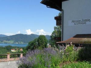 a building with a view of the water and mountains at Pension Seeblick in Attersee am Attersee