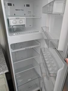 an empty refrigerator with its door open with its at Midtown Place Apartment DORIS 1 with garage in Plovdiv