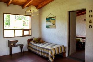 Habitación con cama y ventana en Casa en Tafí del Valle en Tafí del Valle