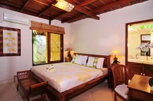 a bedroom with a bed and a sink at Villa Domus De Janas in Seminyak