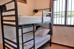 a bunk bed with two bunk beds in a room at Hostal Don Cenobio in Flores