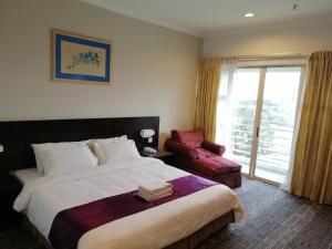 
A bed or beds in a room at StayInn Gateway Hotel Apartment

