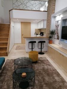 ein großes Wohnzimmer mit einer Theke und einer Küche in der Unterkunft Jolie maison Volos in Volos