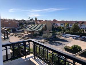 a view from a balcony of a parking lot at Appartamento laurentum in Torvaianica