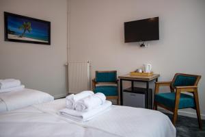 Postel nebo postele na pokoji v ubytování Hotel Guzy