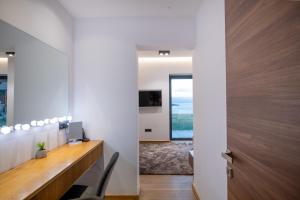 an office with a wooden desk and a door at Villa BLUELINE in Alykes Potamou
