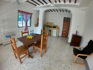 a kitchen and dining room with a table and chairs at kome-Maya garden in Jambiani